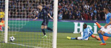 Cristiano Ronaldo slides the ball against the base of the post as Napoli's defence looks on