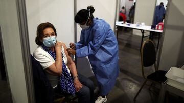A healthcare worker administers a dose of the Oxford-AstraZeneca coronavirus disease (COVID-19) vaccine, marketed by the Serum Institute of India (SII) as COVISHIELD, to Esther Resmik, 81, at a vaccination center in Buenos Aires, Argentina February 22, 2021. REUTERS/Agustin Marcarian
