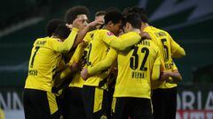 BREMEN, GERMANY - DECEMBER 15: Raphael Guerreiro of Borussia Dortmund (obscured) celebrates with teammates after scoring their team&#039;s first goal during the Bundesliga match between SV Werder Bremen and Borussia Dortmund at Wohninvest Weserstadion on December 15, 2020 in Bremen, Germany. Sporting stadiums around Germany remain under strict restrictions due to the Coronavirus Pandemic as Government social distancing laws prohibit fans inside venues resulting in games being played behind closed doors.  (Photo by Focke Strangmann - Pool/Getty Images)