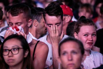 LONDON, ENGLAND  - JULY 11: England football fans react after their defeat as they watch the Hyde Park screening of the FIFA 2018 World Cup semi-final match between Croatia and England on July 11, 2018 in London, United Kingdom.The winner of this evening'