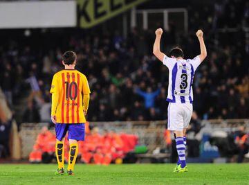 Real Sociedad's defender Mikel Gonzalez (R) celebrates their victory past Barcelona's Argentinian forward Lionel Messi at teh end of the Spanish league football match Real Sociedad vs FC Barcelona at the Anoeta stadium in San Sebastian on April 9, 2016. /