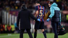 Barcelona's Spanish midfielder Sergio Busquets is escorted off pitch after an injury during the Spanish league football match between FC Barcelona and Sevilla FC at the Camp Nou stadium in Barcelona, on February 5, 2023. (Photo by Josep LAGO / AFP)