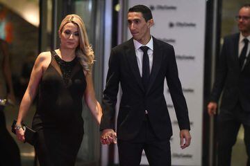 Paris Saint Germain's footballer Argentine Angel di Maria poses with his wife on a red carpet during Argentine football star Lionel Messi and Antonella Roccuzzo\x92s wedding in Rosario, Santa Fe province, Argentina on June 30, 2017.
