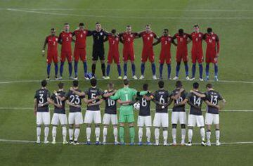 The German, front, and the English team observe a minute of silence to commemorate the victims of the Brussels terror attacks during a friendly soccer match between Germany and England in Berlin, Germany, Saturday, March 26, 2016.