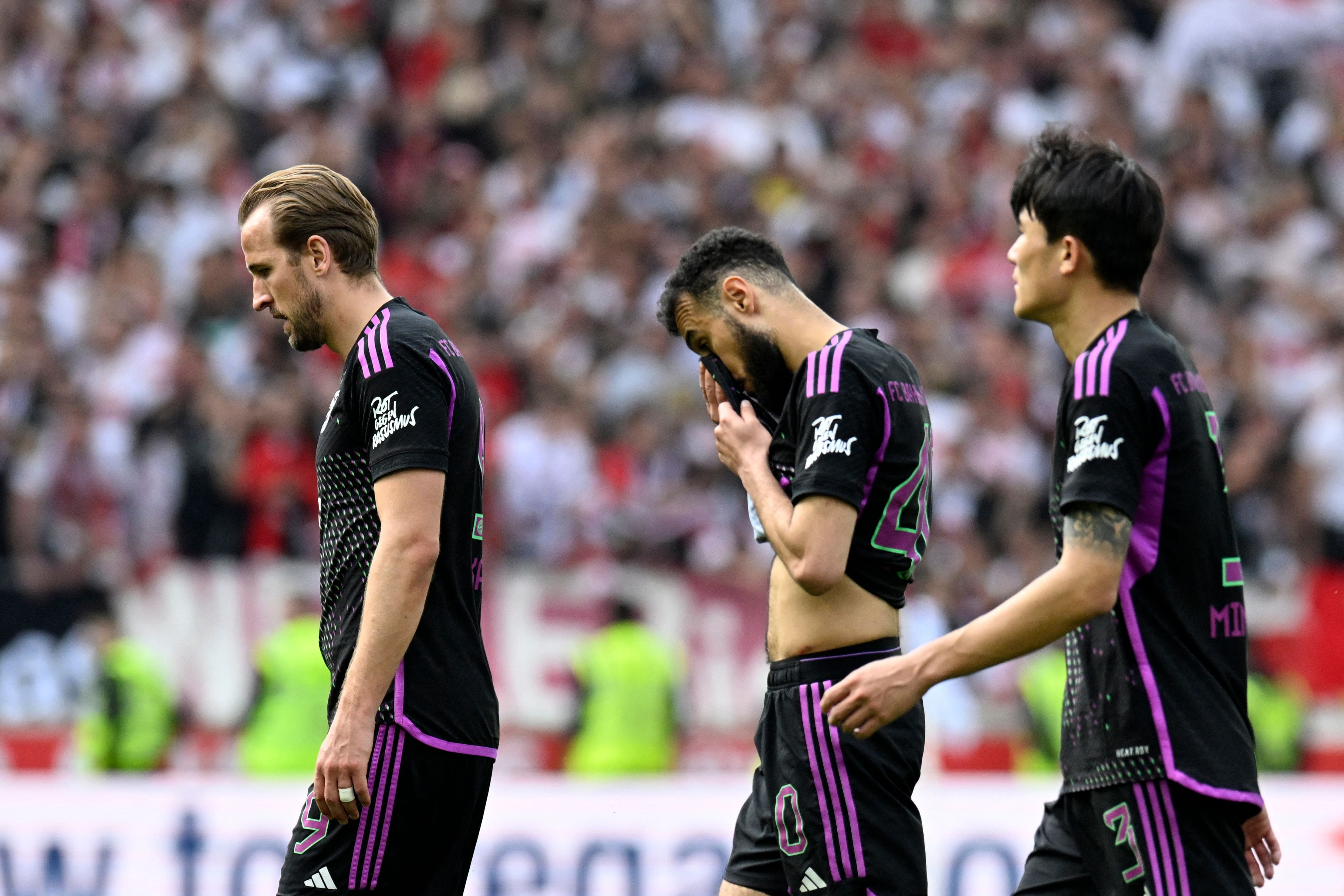 (LtoR) Bayern Munich's English forward #09 Harry Kane, Bayern Munich's Moroccan defender #40 Noussair Mazraoui and Bayern Munich's South Korean defender #03 Kim�Min-Jae leave the pitch after the German first division Bundesliga football match between VfB Stuttgart and FC Bayern Munich in Stuttgart, southwestern Germany on May 4, 2024. Stuttgart won the match 3-1. (Photo by THOMAS KIENZLE / AFP) / DFL REGULATIONS PROHIBIT ANY USE OF PHOTOGRAPHS AS IMAGE SEQUENCES AND/OR QUASI-VIDEO