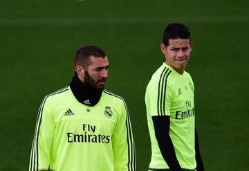 James (right) in training with Real Madrid team-mate Karim Benzema.