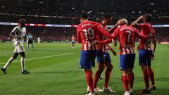 Atletico Madrid's French forward #07 Antoine Griezmann is congratulated for scoring his team's second goal during the Spanish Liga football match between Club Atletico de Madrid and Real Madrid CF at the Metropolitano stadium in Madrid on September 24, 2023. (Photo by Oscar del Pozo / AFP)