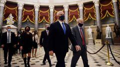 US Vice President Mike Pence (C) walks back from the House Chamber followed by a Senate procession carrying boxes of Electoral Votes, at the Capitol, on January 7, 2021 in Washington, DC. - Congress was on track on January 7, 2021 to certify Joe Biden as 