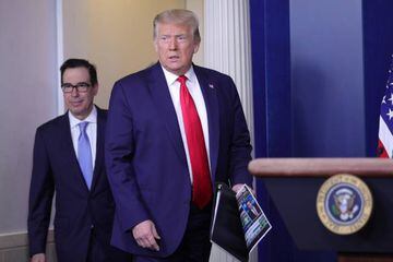 U.S. President Donald Trump arrives with Treasury Secretary Steven Mnuchin to address a press briefing on the U.S. economy.