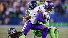 SEATTLE, WA - DECEMBER 10: Stefon Diggs #14 of the Minnesota Vikings tries to fight through a tackle by Tre Flowers #37 and Shaquill Griffin #26 of the Seattle Seahawks at CenturyLink Field on December 10, 2018 in Seattle, Washington.   Otto Greule Jr/Get