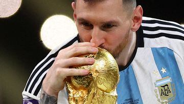 FILE PHOTO: Soccer Football - FIFA World Cup Qatar 2022 - Final - Argentina v France - Lusail Stadium, Lusail, Qatar - December 18, 2022 Argentina's Lionel Messi kisses the trophy as he celebrates winning the World Cup REUTERS/Carl Recine/File Photo