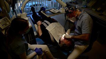 Hungarian dentist Ivan Solymosi checks British patient Bob Martin's implants at the Kreativ Dental Clinic in Budapest, Hungary, February 10, 2023. REUTERS/Marton Monus