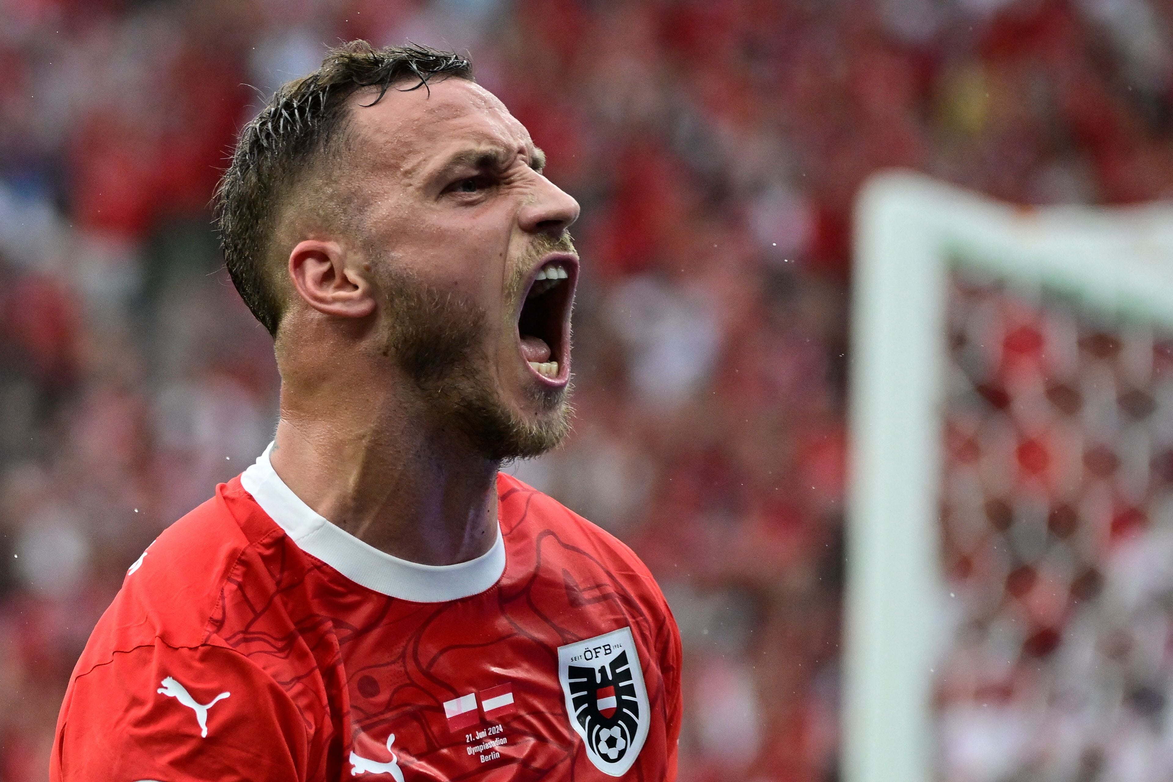 Austria's forward #07 Marko Arnautovic celebrates scoring his team's third goal during the UEFA Euro 2024 Group D football match between Poland and Austria at the Olympiastadion in Berlin on June 21, 2024. (Photo by JOHN MACDOUGALL / AFP)
