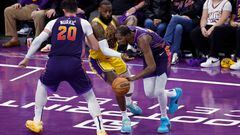 Kevin Durant, #35 of the Phoenix Suns, dribbles around a screen set by Jusuf Nurkic #20 on LeBron James #23 of the Los Angeles Lakers