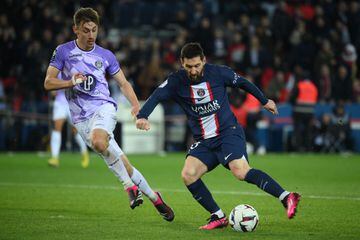 Lionel Messi fights for the ball with Toulouse defender Anthony Rouault at the Parc des Princes stadium on February 4, 2023.