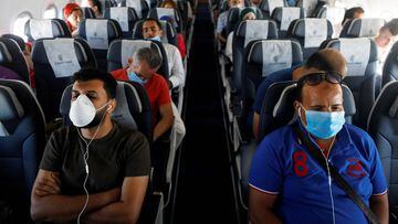 FILE PHOTO: Passengers wearing protective face masks sit on a plane at Sharm el-Sheikh International Airport, following the outbreak of the coronavirus disease (COVID-19), in Sharm el-Sheikh, Egypt, June 20, 2020. REUTERS/Mohamed Abd El Ghany/File Photo