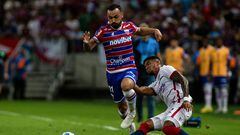 Fortaleza's forward Moises (L) and San Lorenzo's Colombian defender Rafael Perez vie for the ball during the Copa Sudamericana group stage second leg football match between Brazil's Fortaleza and Argentina's San Lorenzo, at the Arena Castelao stadium in Fortaleza, Brazil, on May 24, 2023. (Photo by Thiago Gadelha / AFP)