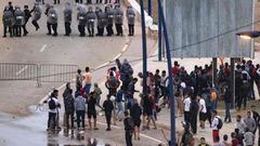 Migrants face-off with Moroccan riot police in the northern town of Fnideq, close to the border between Morocco and Spain&#039;s North African enclave of Ceuta on May 19, 2021. - Migrants were still trying to cross from Morocco into the Spanish enclave of