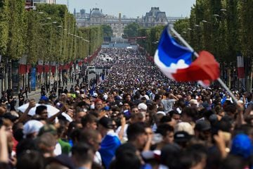 Supporters gather on the Champs-Elysees avenue near the Place de la Concorde (Concorde's Square) in Paris on July 16, 2018 as they wait for the arrival of the French national football team for celebrations after France won the Russia 2018 World Cup final 