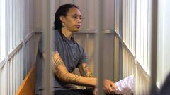 US Women's National Basketball Association (NBA) basketball player Brittney Griner, who was detained at Moscow's Sheremetyevo airport and later charged with illegal possession of cannabis, sits inside a defendants' cage after the court's verdict during a hearing in Khimki outside Moscow, on August 4, 2022. - A Russian court found Griner guilty of smuggling and storing narcotics after prosecutors requested a sentence of nine and a half years in jail for the athlete. (Photo by EVGENIA NOVOZHENINA / POOL / AFP)