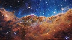 IN SPACE - JULY 12: In this handout photo provided by NASA, a landscape of mountains and valleys speckled with glittering stars is actually the edge of a nearby, young, star-forming region called NGC 3324 in the Carina Nebula, on July 12, 2022 in space. Captured in infrared light by NASA's new James Webb Space Telescope, this image reveals for the first time previously invisible areas of star birth.  (Photo by NASA, ESA, CSA, and STScI via Getty Images)