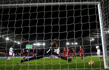 Alfie Mawson of Swansea City scores his side's first goal past Loris Karius of Liverpool during the Premier League match between Swansea City and Liverpool at Liberty Stadium on January 22, 2018 in Swansea, Wales.