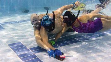 In this photo taken on February 15, 2017, members of the &quot;HK Typhoon&quot; underwater hockey club fight for possession of the puck (front C) during their once-a-week team practise session at a 25-metre school pool in Hong Kong. The gravity defying sport of underwater hockey has gained a worldwide following -- now a Hong Kong team is diving in as the game takes off in Asia. / AFP PHOTO / Anthony WALLACE / TO GO WITH HongKong-sport-lifestyle-underwater-hockey,FEATURE by Aaron TAM