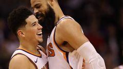 PHOENIX, AZ - DECEMBER 31: Devin Booker #1 of the Phoenix Suns celebrates with Tyson Chandler #4 after scoring against the Philadelphia 76ers during the second half of the NBA game at Talking Stick Resort Arena on December 31, 2017 in Phoenix, Arizona. The 76ers defeated the Suns 123-110. NOTE TO USER: User expressly acknowledges and agrees that, by downloading and or using this photograph, User is consenting to the terms and conditions of the Getty Images License Agreement.   Christian Petersen/Getty Images/AFP == FOR NEWSPAPERS, INTERNET, TELCOS &amp; TELEVISION USE ONLY ==