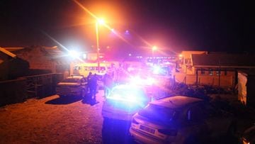 Police are seen outside a township pub in South Africa's southern city of East London on June 26, 2022, after 20 teenagers died inside. - At least 20 teenagers, the youngest aged just 13 years, have died at a township pub in South Africa's southern city of East London, but the cause of the deaths is still unclear. Crowds of people including parents whose children were missing gathered outside the tavern located along a street in a residential township as mortuary vehicles collected bodies, according to an AFP correspondent. (Photo by AFP) (Photo by STR/AFP via Getty Images)