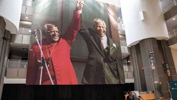 An image depicting the late South African Nobel Peace Price Archbishop Desmond Tutu and the late South African President and Nobel Peace prize laureate Nelson Mandela raising their fists hangs in the main hall of the Cape Town City Centre while  Anglican 