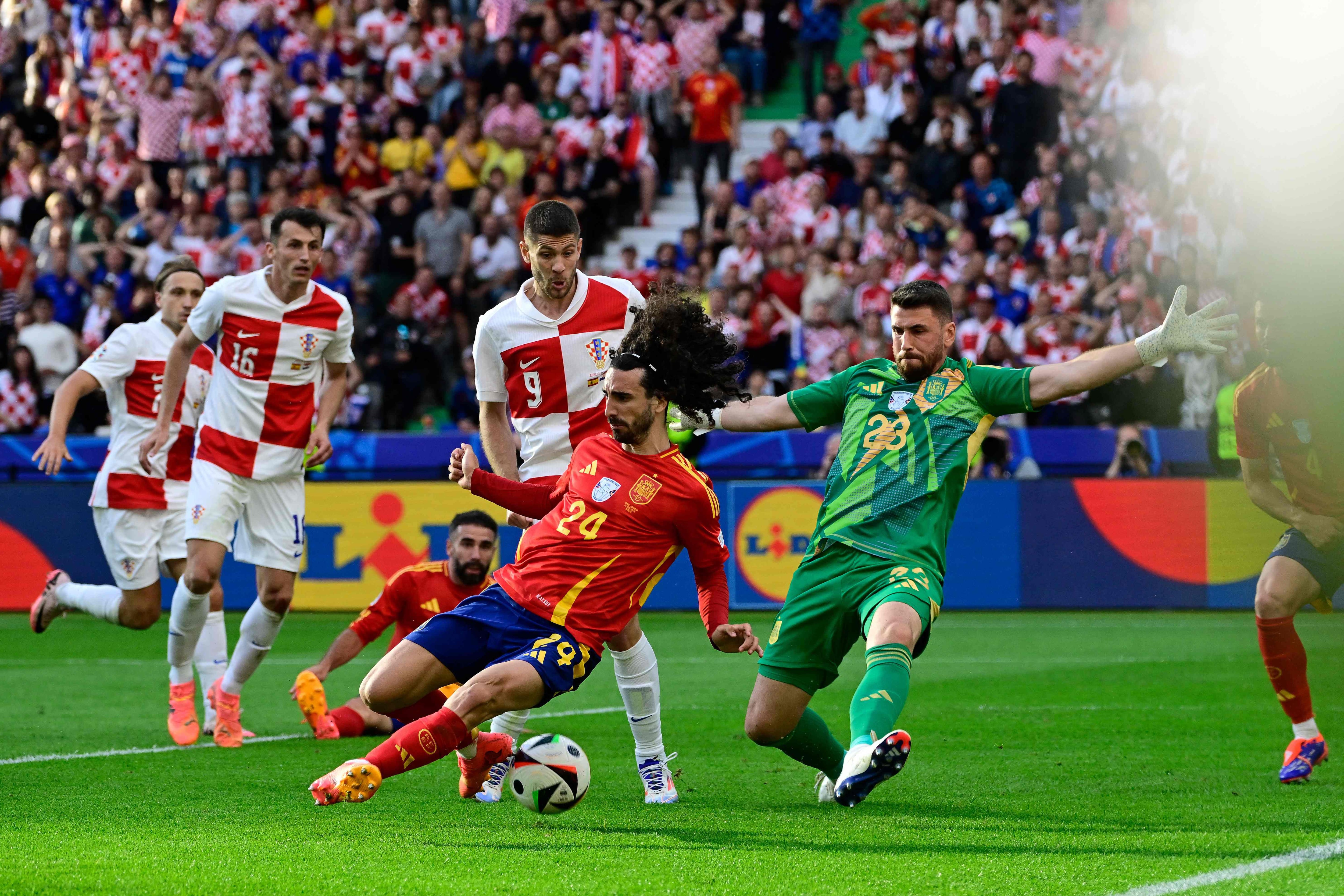 Spain's defender #24 Marc Cucurella and Spain's goalkeeper #23 Unai Simon try to block a shot during the UEFA Euro 2024 Group B football match between Spain and Croatia at the Olympiastadion in Berlin on June 15, 2024. (Photo by JOHN MACDOUGALL / AFP)