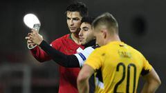FARO, PORTUGAL - NOVEMBER 14: Fan of Cristiano Ronaldo goes onto the pitch to take a picture with Ronaldo during the UEFA Euro 2020 Qualifier match between Portugal and Lithuania at Algarve Stadium on November 14, 2019 in Faro, Portugal. (Photo by Octavio Passos/Getty Images)