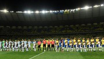Players of Argentina (L) and Brazil listen to their national anthems before the start of their 2018 FIFA World Cup qualifier football match in Belo Horizonte, Brazil, on November 10, 2016. / AFP PHOTO / DOUGLAS MAGNO