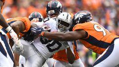 Oct 1, 2017; Denver, CO, USA; Oakland Raiders running back Jalen Richard (30) is tackled by inside linebacker Brandon Marshall (54) and defensive end Derek Wolfe (95) and defensive end Shelby Harris (96) in the second quarter at Sports Authority Field at Mile High. Mandatory Credit: Ron Chenoy-USA TODAY Sports
