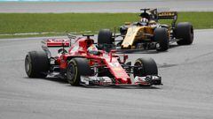 Formula One F1 - Malaysia Grand Prix 2017 - Sepang, Malaysia - October 1, 2017. Ferrari&acirc;s Sebastian Vettel in action ahead of Renault&acirc;s Nico Hulkenberg during the race. REUTERS/Edgar Su
