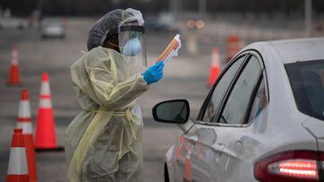 A healthcare worker holds a coronavirus disease (COVID-19) informational pamphlet for a resident at a drive-thru testing location in Houston, Texas, U.S., November 20, 2020.   REUTERS/Adrees Latif