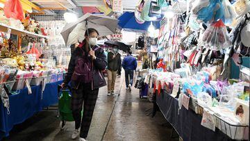A woman looks at face masks for sale at a market in Hong Kong on February 17, 2022, as the city faces its worst Covid-19 outbreak since the start of the pandemic. 