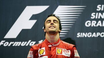 Winning Ferrari driver Fernando Alonso of Spain reacts during the awards ceremony on the podium for Formula One&#039;s Singapore Grand Prix at Marina Bay Street Circuit in Singapore on September 26, 2010. Alonso won an incident-packed Singapore Grand Prix