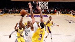 Memphis Grizzlies guard Ja Morant (L) drives to the basket while being guarded by Los Angeles Lakers forward Anthony Davis (R)
