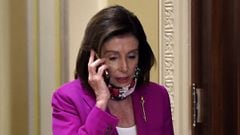 House Speaker Nancy Pelosi talks on her phone at the US Capitol on May 15, 2020 in Washington, DC. - US House Democrats aim to pass a record $3 trillion coronavirus response package Friday to fund the fight against the pandemic and provide emergency payme