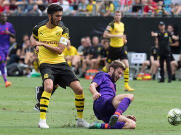 Liverpool's Adam Lallana (R) vies for the ball with Borussia Dortmund's Nuri Sahin (L) during the 2018 International Champions Cup at Bank of America Stadium in Charlotte, North Carolina, on July 22, 2018.  / AFP PHOTO / JIM WATSON