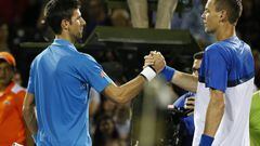 Novak Djokovic and Tomas Berdych shake hands at the net. 