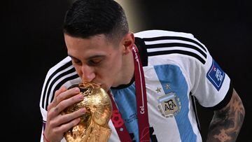 Argentina's midfielder #11 Angel Di Maria kisses the FIFA World Cup Trophy during the trophy ceremony after Argentina won the Qatar 2022 World Cup final football match between Argentina and France at Lusail Stadium in Lusail, north of Doha on December 18, 2022. (Photo by Kirill KUDRYAVTSEV / AFP)