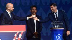 Argentine former football player Javier Zanetti (R) picks up a ball from the pot and hands it over toC ONCACAF's Chief Football Competitions Officer Carlos Fernandez (L) during the final draw for the Conmebol Copa America 2024 football competition at the James L. Knight Centre in Miami, Florida, on December 7, 2023. (Photo by GIORGIO VIERA / AFP)