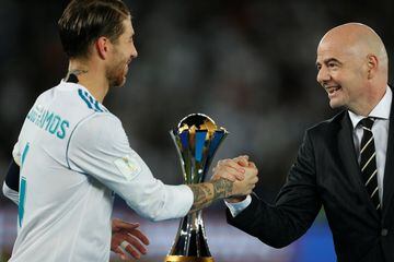Real Madrid’s Sergio Ramos celebrates with an award as he shakes the hand of FIFA President Gianni Infantino after the game