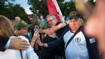 Veterans emotionally embrace during a news conference, following the completion of a vote on the Promise to Address Comprehensive Toxics (PACT) Act on Capitol Hill.
