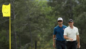 Adam Scott of Australia and Rory McIlroy of Northern Ireland walk onto the 18th green during the second round of the 2018 Masters Tournament