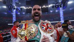 Tyson Fury celebrates with the belts after winning his fight against Dillian Whyte.
