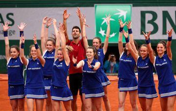 Novak gets the ball girls involved in his celebrations.
