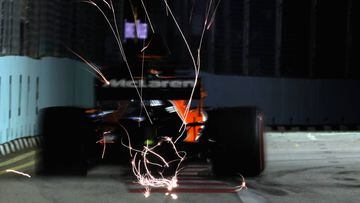 SINGAPORE - SEPTEMBER 15: Sparks fly behind Fernando Alonso of Spain driving the (14) McLaren Honda Formula 1 Team McLaren MCL32 on track during practice for the Formula One Grand Prix of Singapore at Marina Bay Street Circuit on September 15, 2017 in Singapore.  (Photo by Mark Thompson/Getty Images)
